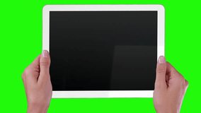 Tablet with MRI videos. Green screen. White. Woman using a futuristic digital tablet. Medical interface. Head MRI videos on the screen. More options in my portfolio.