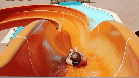 Young Boy Riding On Orange Water Slide To The Pool. Aquapark, Water Park, Holidays, Hotel, Happiness, Summer. HD, Size: 1080p (1920x1080), Sound: No 