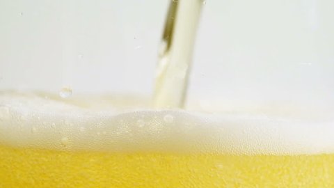 Golden light beer being poured into a glass