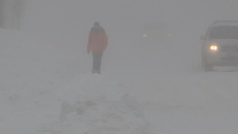 Waterloo, Ontario, Canada January 2014 Diverse people walking in blizzard snow wind  cold weather in major winter storm
