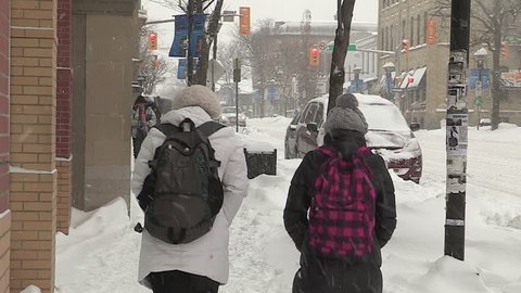Waterloo, Ontario, Canada January 2014 Diverse people walking in blizzard snow wind  cold weather in major winter storm
