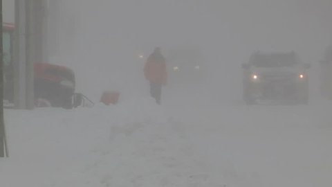 Ontario, Canada January 2013 Diverse people walking in blizzard snow wind  cold weather in major winter storm
