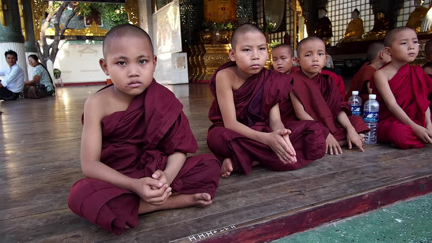 Yangon, Myanmar - March 7: Novice Buddhist monks sitting outside temple at sacred Shwedagon Pagoda in Yangon, Myanmar (Burma). | Shutterstock HD Video #11755661
