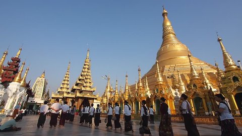Yangon, Myanmar - March 12: Tourists and locals walking around sacred Shwedagon Pagoda in Yangon, Myanmar (Burma).