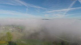 Aerial flight over a sea of fog near Sursee in Switzerland
