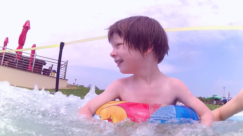 Little girl enjoying in Jacuzzi swimming pool bubbles and smiling