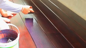 video clip of hand painting oil color on wood floor use for home decorated ,house renovation and housing construction theme