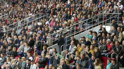 Chelyabinsk, Russia - September 19, 2015: Fans happily stand up from their seats when the team scores.