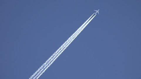 4K View of Airplane jet layer, aircraft pollution on sky, white trace vapour by day