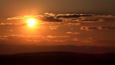4K Timelapse of sun silhouette at sunrise or sunset, peaceful ray light among cloud, misty skyscape by day