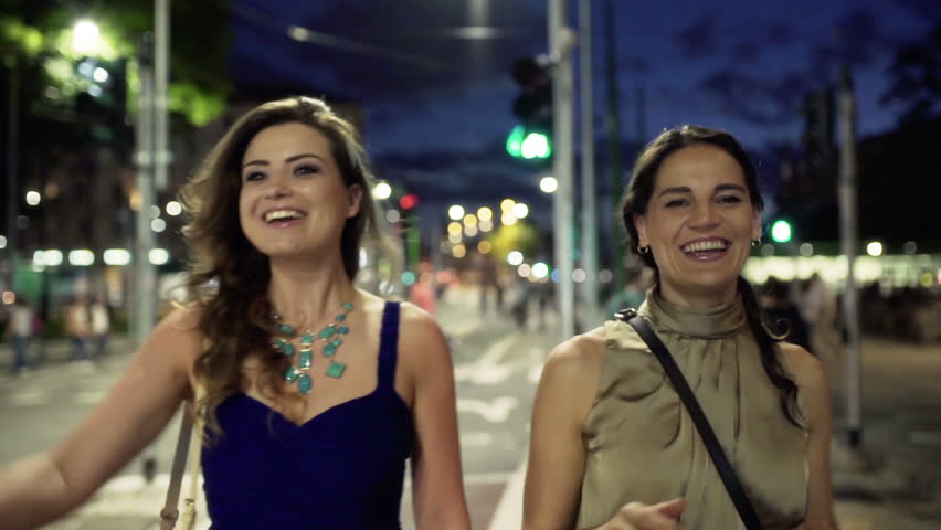 Friends meeting in the street at night, steadycam shot
 | Shutterstock HD Video #11783198