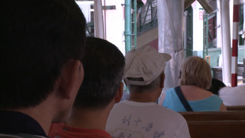 Hong Kong, China - July 2009: Chinese people and tourists sitting on a passenger ferry as it approaches the dock. Hong Kong, China. | Shutterstock HD Video #11786432