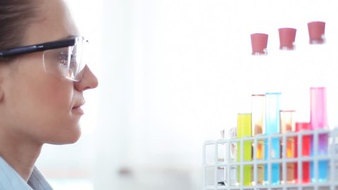Female scientist mixing chemicals in volumetric flask