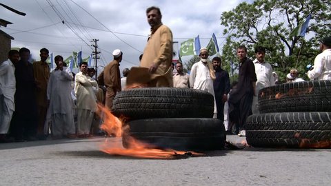ABBOTTABAD, PAKISTAN - MAY 6: Anti US protesters burn tires at a rally held by Islamist parties against the killing of Osama Bin Laden earlier in the week on May 2, 2011. Anti US Protest Recorded on May 6, 2011. 