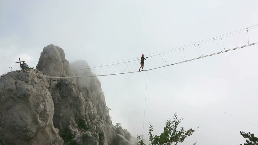 Young Woman Crossing the Chasm Stock Footage Video (100% Royalty-free