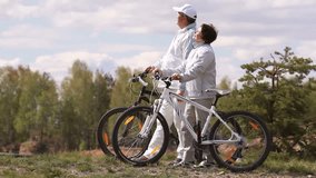 Senior couple standing with their bicycles and communicating