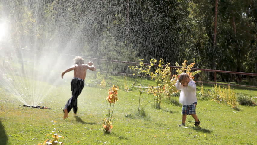 playing in sprinkler