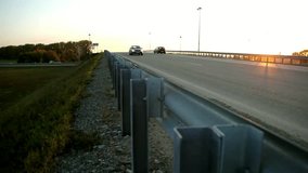 road with fencing.transport interchange at sunset.the limiter on the road.the movement of the machine.early autumn.evening. - Powered by Shutterstock - Get 15% off with code: PIKWIZARD15