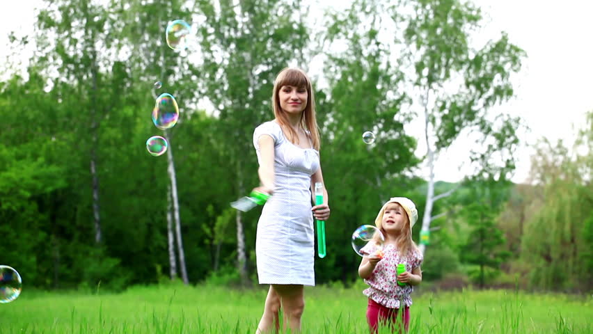 Mother and daughter with a giant soap bubbles 