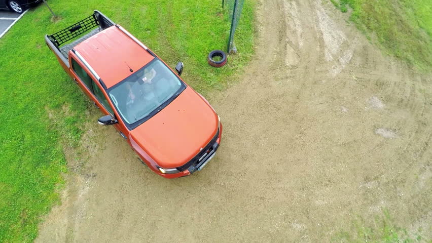 his is an air view on pick-up driver on off road court with pick up on a countryside which is used for training off road driving.