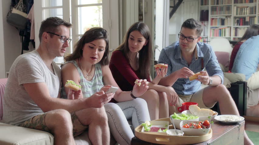 Friends sitting on the sofa and eating lunch together
 | Shutterstock HD Video #11816549