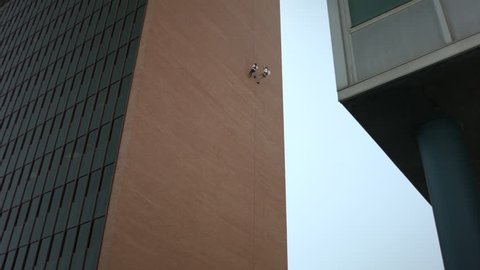 This is a shot of two people rappelling down the side of a building. Shot on a BMCC