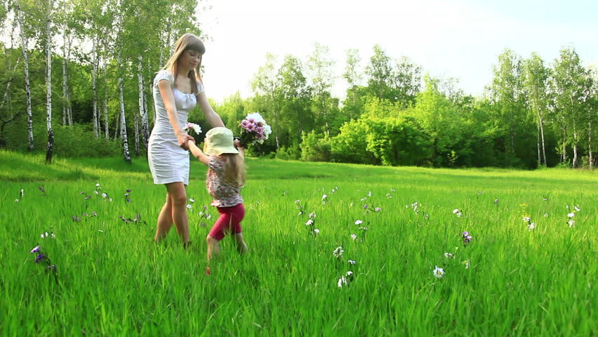 Mother and child dancing in the field. Mother kisses her daughter. Dolly HD 