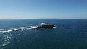 Aerial video of rocks out in the ocean at Newport Beach, Oregon.