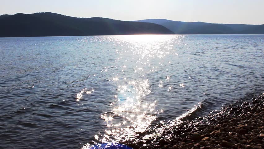 the glare of the sun on the lake