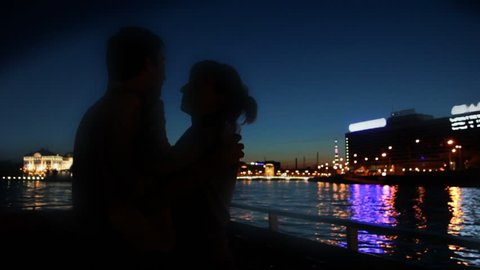 Couple dancing on ship sailing along Neva River at night