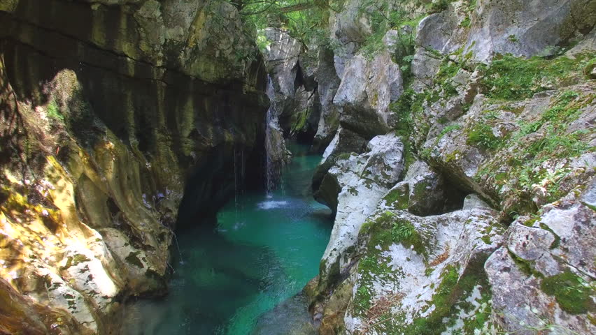 AERIAL: Emerald water running through the narrow canyon