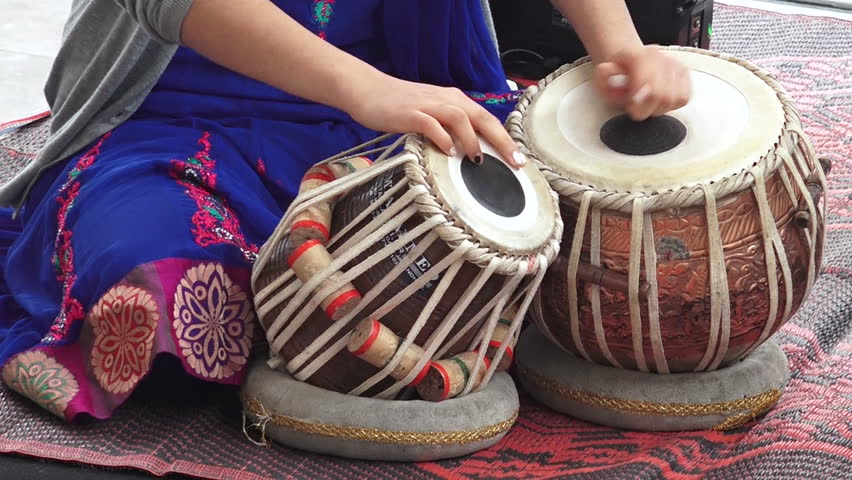 Indian woman hands playing on Indian musical instrument Tabla Punjabi drums during a Hindu holiday festival ceremony. Royalty-Free Stock Footage #11860211