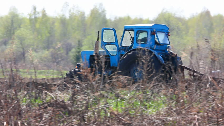 tractor plowing at spring