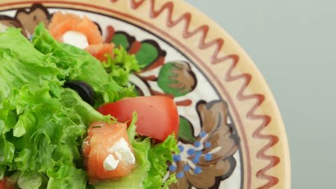 fresh salad with salmon on the decorative plate
