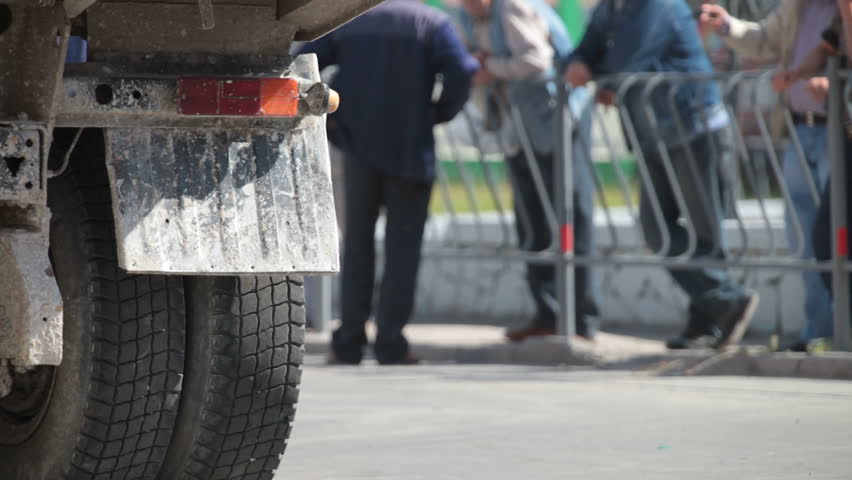 truck with the Flashing Hazard Lights on urban road