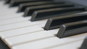 Electric piano keyboard keys shallow DOF musical 4K 2160p 30fps UHD pan footage - Panning over synthesizer black and white keys 4K 3840X2160 UltraHD video