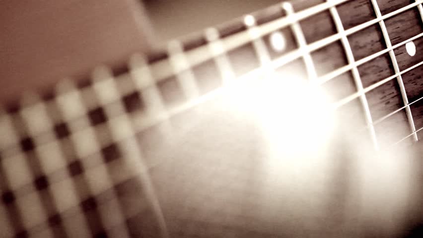 Macro of guitar strings and a microphone