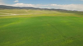 Aerial video in the countryside of Montana of crops and a semi truck