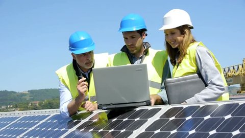 Engineers checking solar panels setup