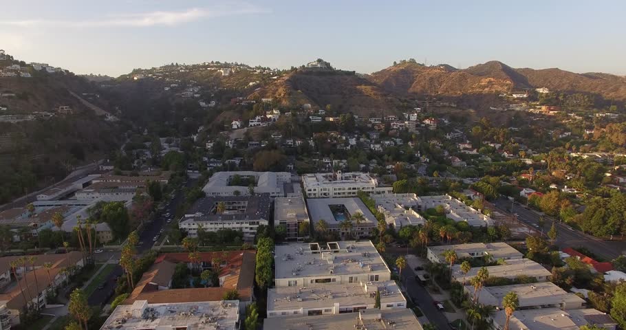 Low altitude aerial flight above Los Angeles upward to Hollywood Hills. 4K UHD.