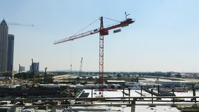 Tracking shot of buildings with cranes, Dubai, United Arab Emirates