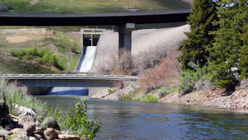 Spring runoff spills over the dam's spillway.