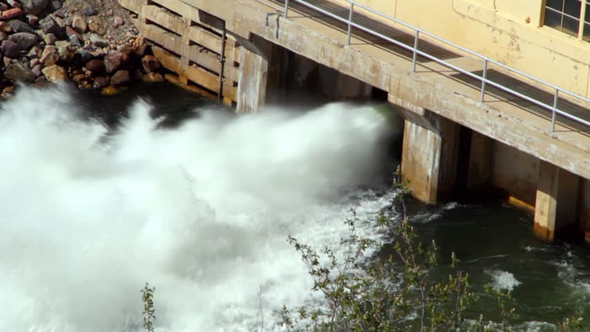High flood waters are being released through the dam.