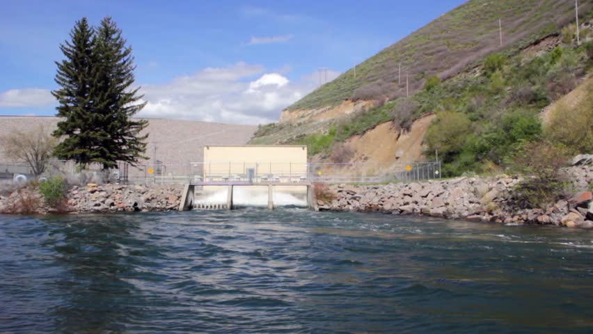 High flood waters cause the sluice gates on the dam to open