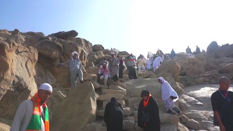 MECCA, SAUDI ARABIA - CIRCA MARCH, 2015: Muslims hiking to Mount Arafat (or Jabal Rahmah). This is the place where Adam and Eve met after being overthrown from heaven.