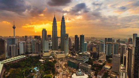 Time lapse: Beautiful and dramatic sunset view of the Kuala Lumpur skyline overlooking the national landmarks,  the Petronas Towers and Kuala Lumpur Tower.
