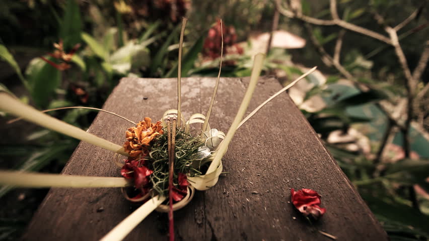 close up of ritual flowers and incense on wood 