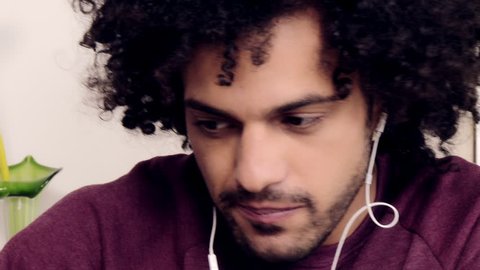 closeup of good looking man enjoying listening music with phone