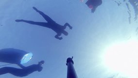 Camera Falling Down and Showing 3 Divers on the surface
