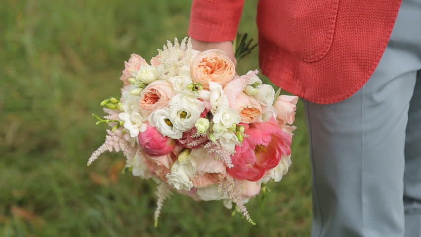 The Groom Holds A Bouquet